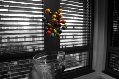 Close-up of multi colored glass on table at home