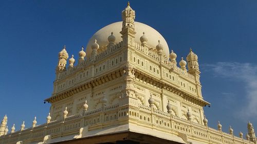 Low angle view of historical building against blue sky