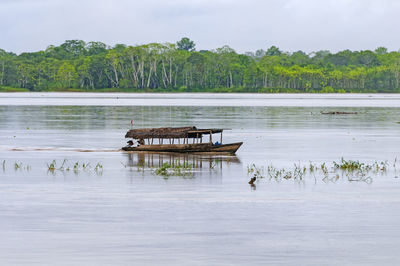 Local shuttle boat on the amazon river near iquitos, peru