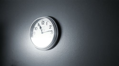 Low angle view of illuminated clock