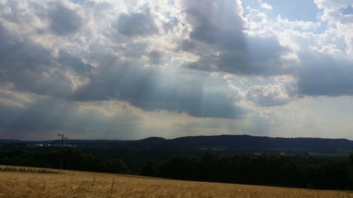 Scenic view of landscape against cloudy sky