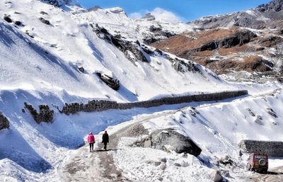 People on snowcapped mountains