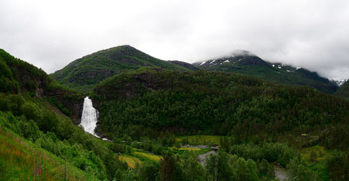 Scenic view of green mountains against sky