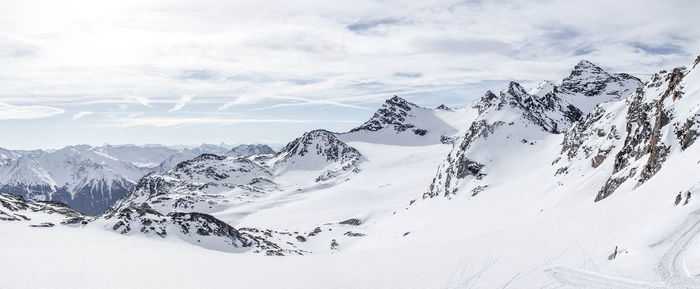 Scenic view of snow covered mountains against sky