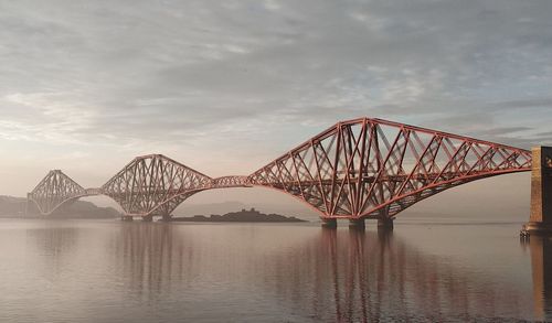 View of bridge over river against cloudy sky