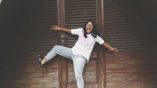 Portrait of a smiling young woman standing at home