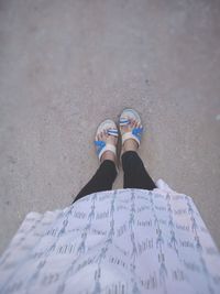 Low section of woman standing on ground