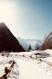 Scenic view of snow covered mountains against clear sky