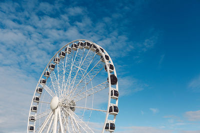 Low angle view of ferris wheel against sky