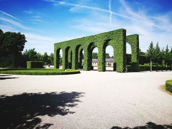 Built structure by trees against sky