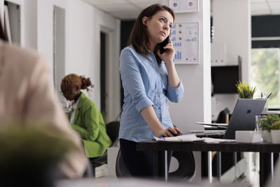 Businesswoman using laptop at office