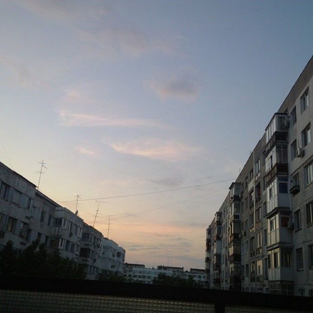 building exterior, architecture, built structure, sky, city, residential structure, residential building, building, sunset, residential district, house, city life, cloud, outdoors, street, cloud - sky, no people, low angle view, day, sunlight