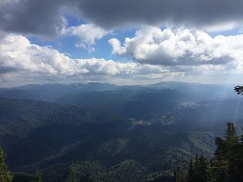 Scenic view of mountains against cloudy sky