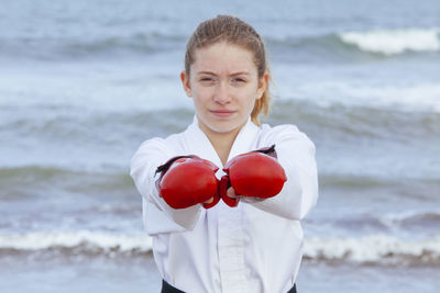 Portrait of woman standing at beach