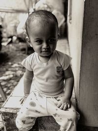 Portrait of cute girl sitting outdoors