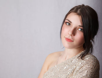 Portrait of a beautiful young woman against white background