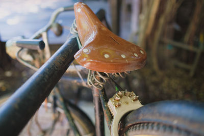 Close-up of rusty bicycle on metal