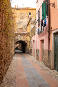Footpath amidst buildings in city