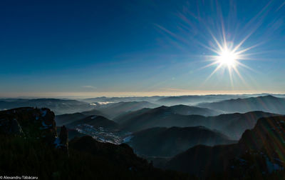 Scenic view of silhouette mountains against blue sky