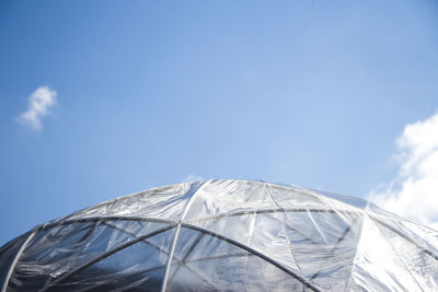 Low angle view of umbrella against blue sky