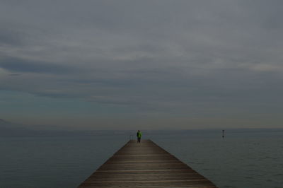 Pier over sea against sky