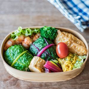 Close-up of wooden container with variety of vegetables and seafood