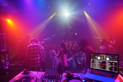 Crowd enjoying music concert at night