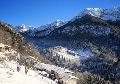 High angle view of snowcapped mountains against clear sky