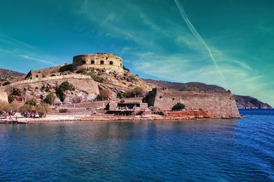 Crete, greece wide angle view of spinalonga unhabited island with a 16th century venetian fortress