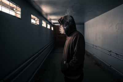 Side view of man standing at railroad station