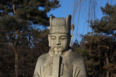 Statue of buddha against trees