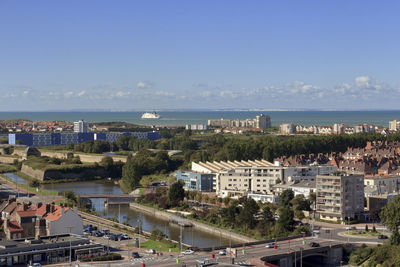 High angle view of buildings and sea against sky