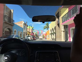 Street seen through car windshield