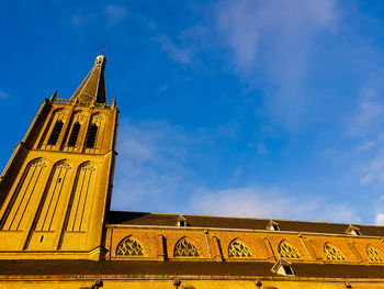 Low angle view of building against blue sky