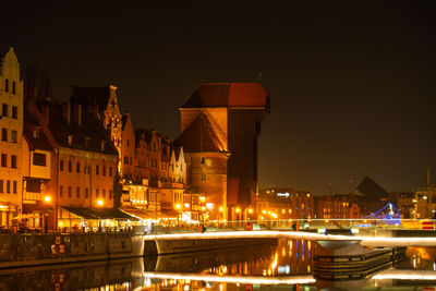 Old town in gdansk at night. the riverside on granary island reflection in moltawa river cityscape