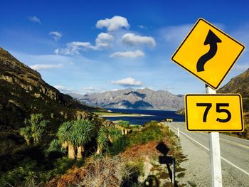 Road sign against blue sky