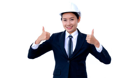 Portrait of a smiling young man against white background