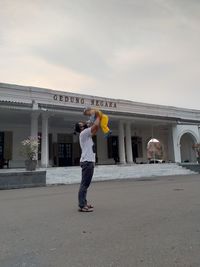 Full length of man standing in city against building