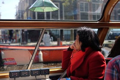 Rear view of woman sitting in train