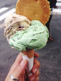 Cropped hand holding ice cream cone