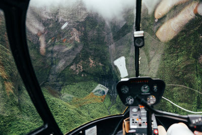 View from inside the helicopter flying into the mountains on the na palicoast on kauai, hawaii.