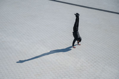 Low section of woman walking on street