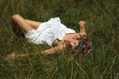 High angle view of woman resting on field