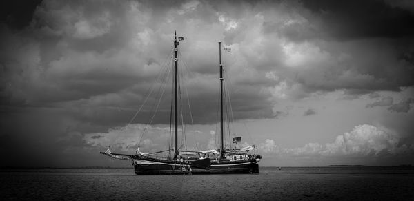 Sailboat sailing in sea against sky