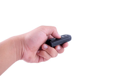 Close-up of hand holding smart phone against white background