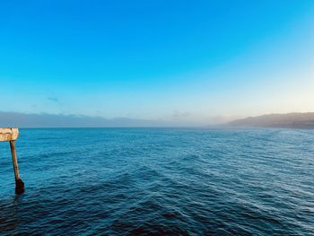 Scenic view of sea against clear blue sky