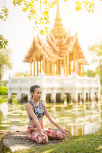 Full length of woman practicing yoga at park