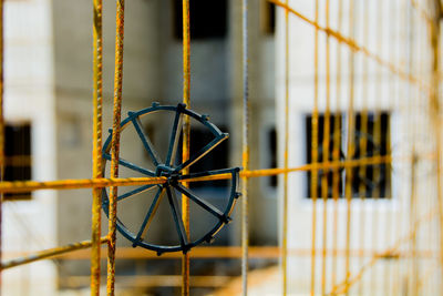 Close-up of metal fence against building