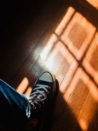 Low section of person wearing shoes on floor