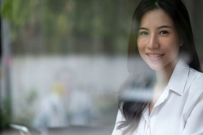 Portrait of young woman using mobile phone